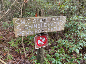 Wooden trail sign in Rothrock State Forest forest with directional arrows and a no horse entry sign. Mid State Trail Shingle Path Penn Roosevelt 
